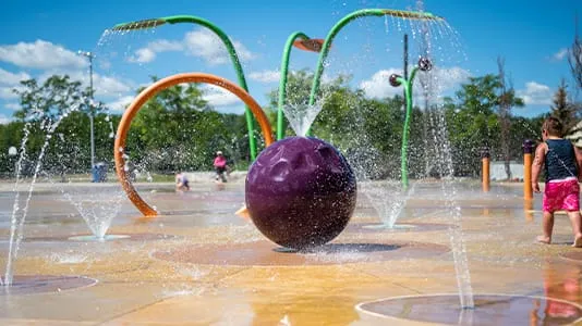 Boy and water at Lampman Lane Splash Pad